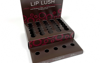 A display box that holds lip product for a skincare brand.